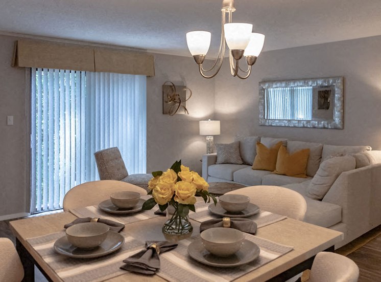dining table set with plates and view of the living room in a Macon GA apartment